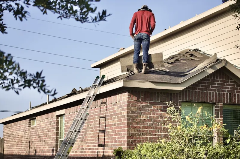 Professional roofer working on a residential roof in Ozona